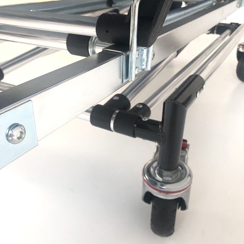 A close-up of a stretcher's locking mechanism and wheels