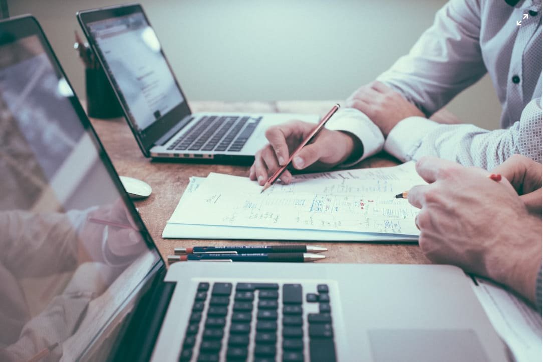 A person in a business setting reviewing documents with a client