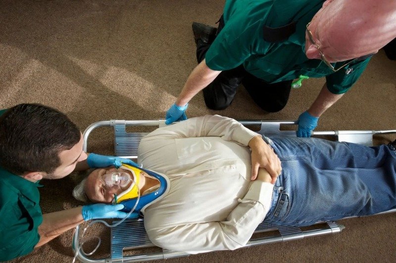 Emergency responders using a scoop stretcher in a confined space simulation