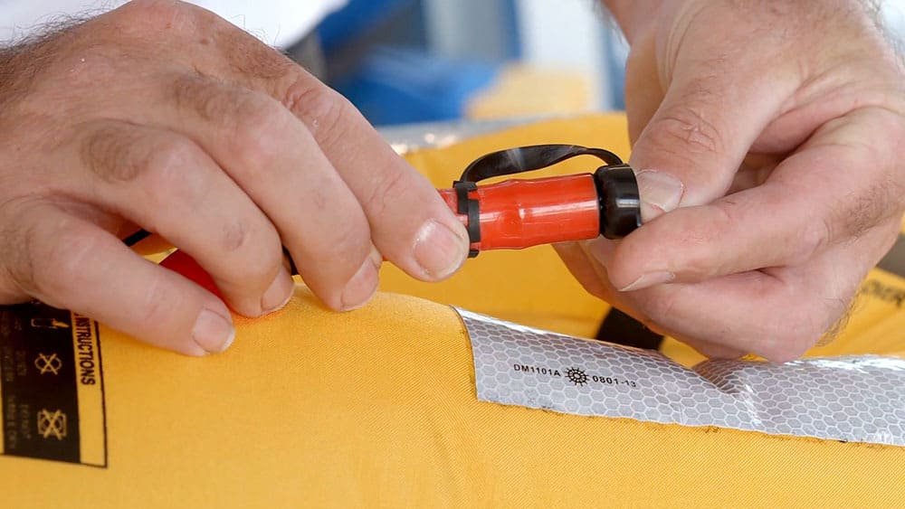 Checking the CO2 cylinder on an inflatable life jacket
