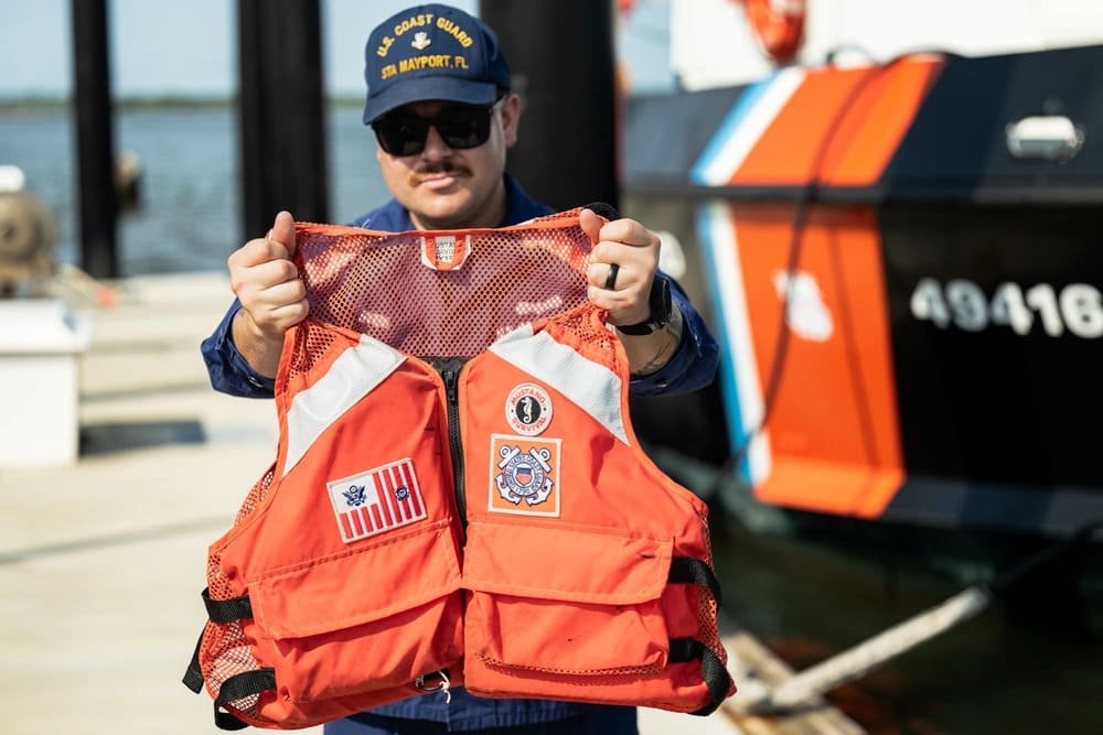 US Coast Guard member presenting a life jacket before use