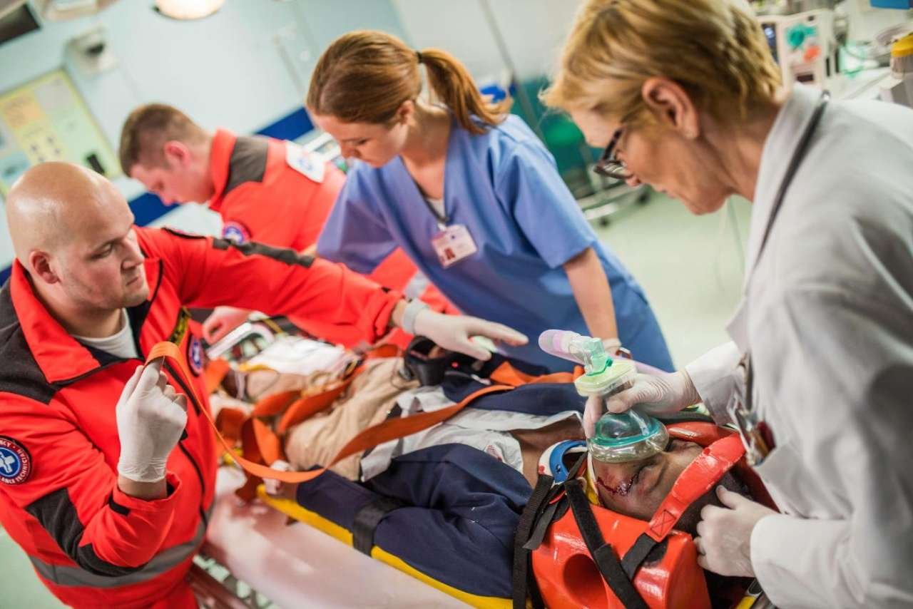 Head Immobilizer Used with a Spine Board Emergency responders securing a patient with a head immobilizer on a spine board