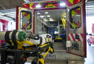 Wheeled stretcher positioned at the rear of an ambulance